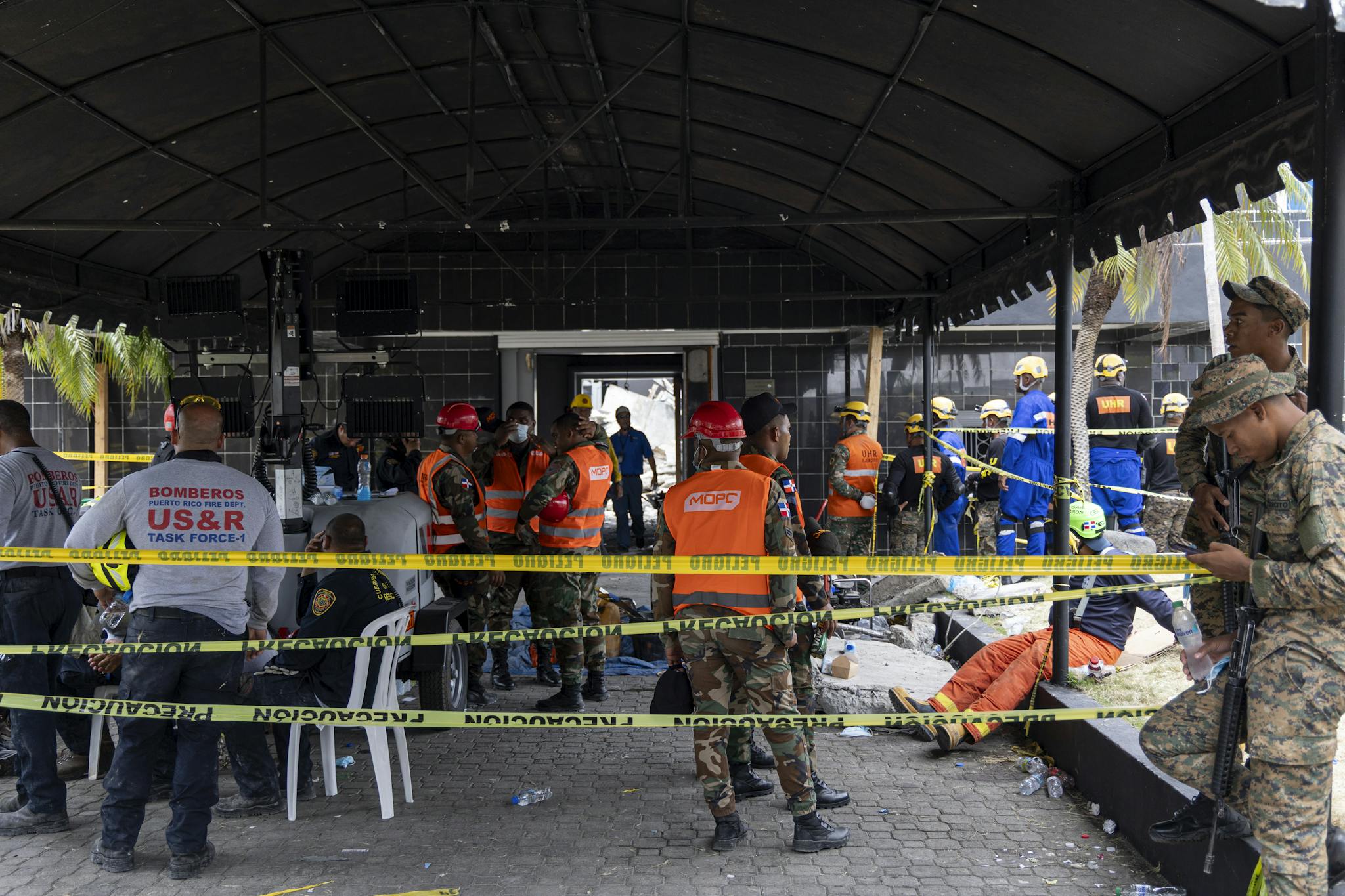 Rescue workers handling emergency operations at a disaster site, focused and coordinated.